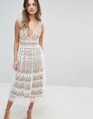 white midi dress and flared lace dress with deep V-neckline