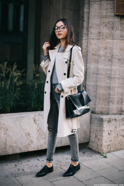 white midi winter trench coat with gray, high-waisted slim fit jeans with cuffs