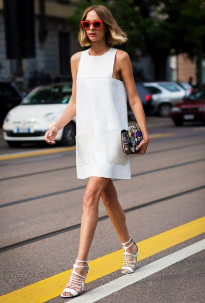 white sleeveless mini sheath dress with matching strappy heels with open toes