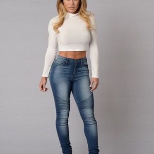 white, cropped, figure-hugging sweater with a blue top and blue, high-waisted jeans