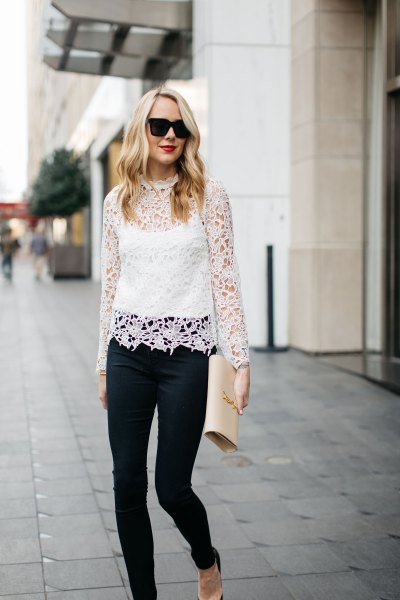 white long-sleeved lace top with stand-up collar over the vest top