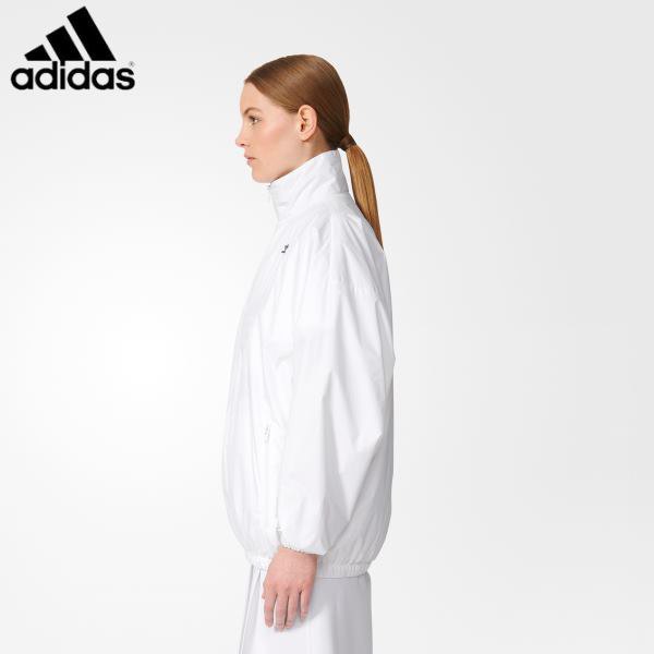 white windbreaker with mock neck and running shorts