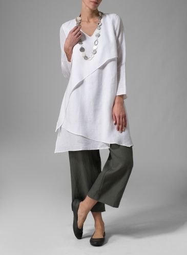 white multi-layer tunic top with gray, short-cut pants with wide legs