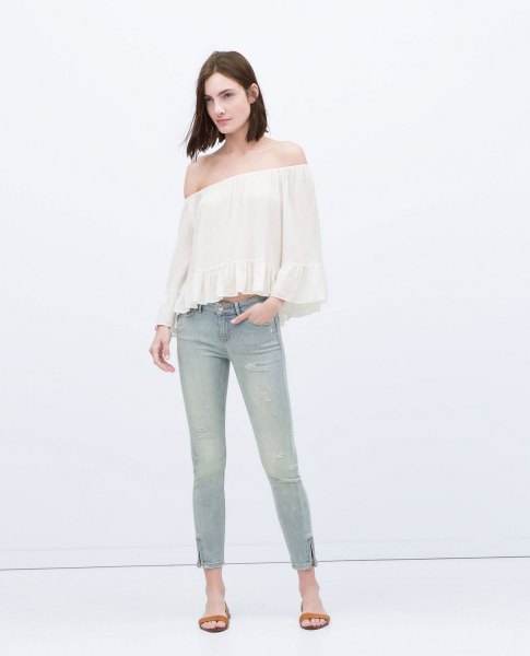 white off-the-shoulder blouse light gray jeans with ankle zip