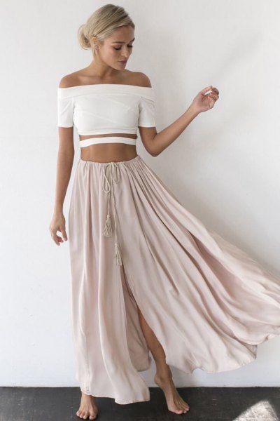 white strapless crop top with light gray, long, flowing skirt