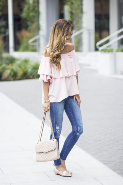 white off-the-shoulder ruffle blouse with blue jeans and pink slippers
