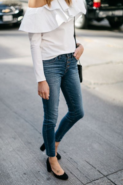 white shoulder blouse with ruffles and jeans with button placket