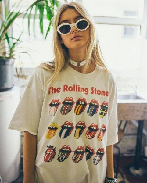 white oversized Rolling Stone t-shirt with high-waisted blue jeans