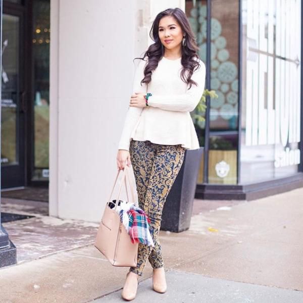 white peplum knit sweater with pink and blue drainpipe trousers with tribal print
