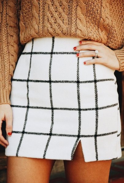 white checked mini skirt with a green, chunky sweater with a cable cutout