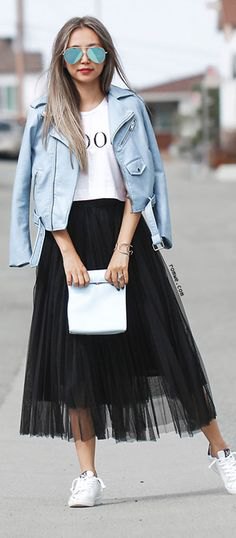white printed T-shirt with blue-green leather jacket and black mesh skirt