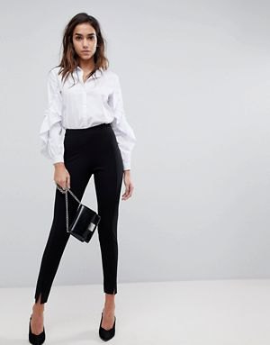 white shirt with puff sleeves and buttons with black chinos