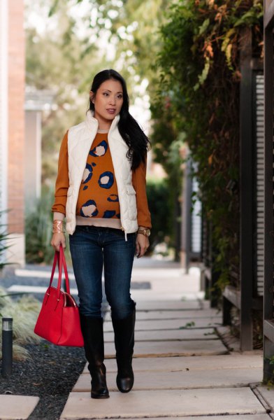 white puffer vest with a red printed pullover