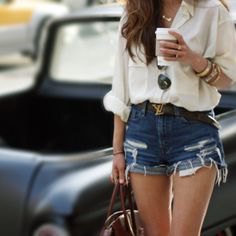 white, loose-fitting linen shirt with ripped blue denim shorts