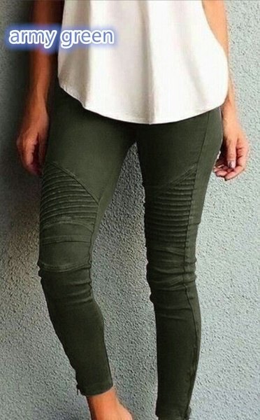 white, loose fitting tank top with dark green, pleated skinny jeans