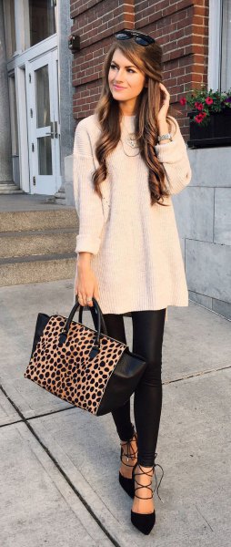 white ribbed large sweater with black leather gaiters