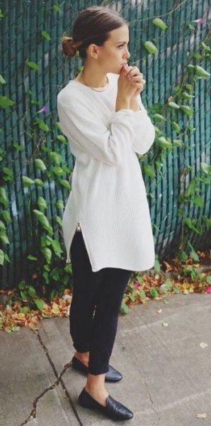 white, ribbed tunic sweater with round neckline and black leather loafers