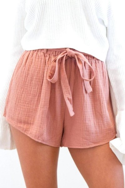white ribbed oversized knitted sweater with pink tie mini chiffon shorts with elastic waist in front