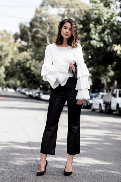 white top with ruffle sleeves, black suit trousers