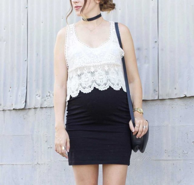white lace top with scalloped hem and black, figure-hugging mini skirt