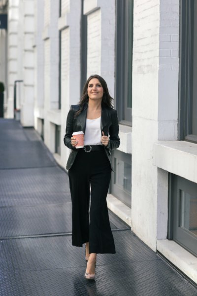 white blouse with scoop neckline and black, cropped pants with wide legs