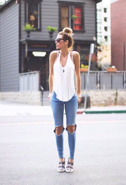 white, loosely cut tank top with scoop neckline and blue skinny jeans