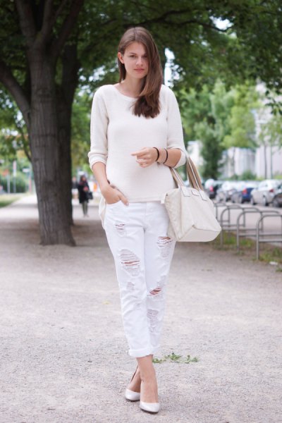 white sweater with scoop neckline and matching boyfriend jeans with ripped edges