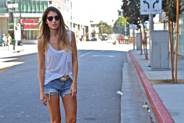 white tank top with scoop neckline and cut off jeans shorts