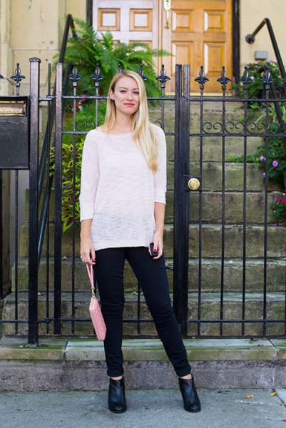 white, semi-transparent slouchy sweater with boat neckline and black jeans