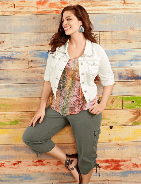 white short-sleeved denim jacket with a colorful top and cargo shorts