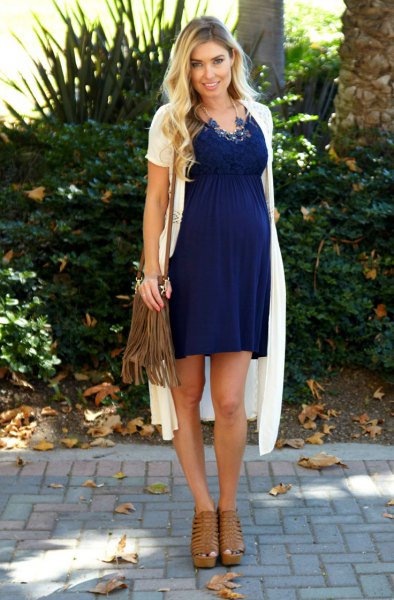 white short-sleeved cardigan with a long knit pattern and blue maternity dress