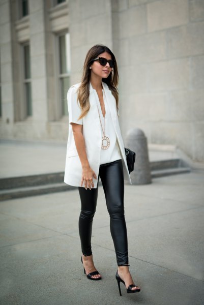 white short-sleeved shirt with black leggings and heels