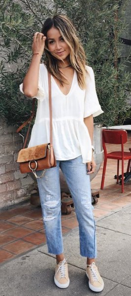 white short-sleeved peplum blouse with V-neck and boyfriend jeans
