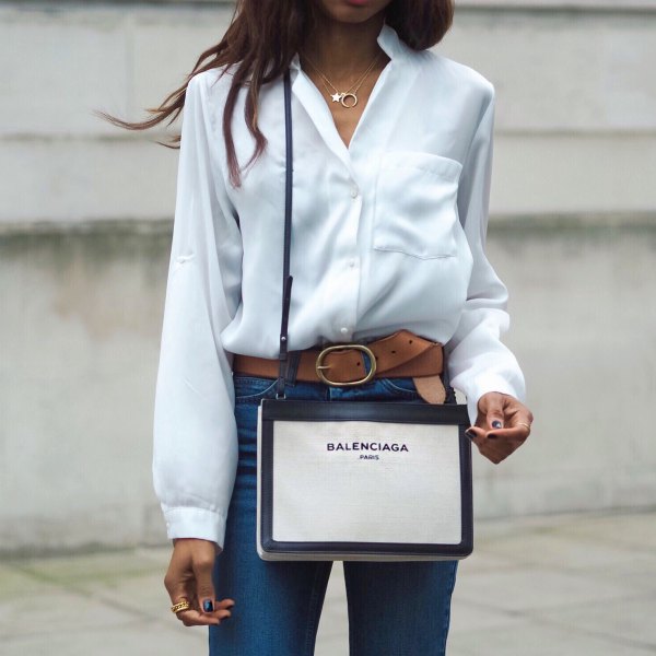 white silk shirt with buttons and blue high-waisted jeans