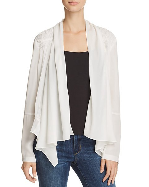 white silk jacket with black vest top and blue skinny jeans