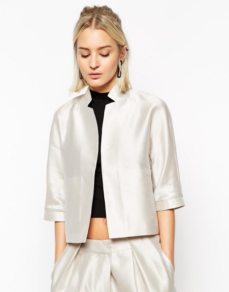 white silk jacket with three-quarter sleeves and black crop top