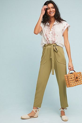 white sleeveless blouse with green, short-cut chinos