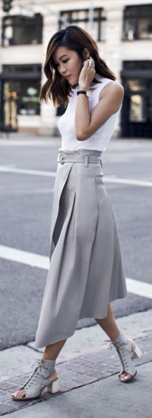 white sleeveless blouse with gray pleated skirt