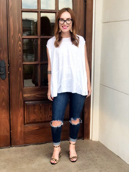 white sleeveless blouse with ripped dark jeans