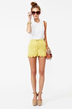 white sleeveless blouse with yellow mini-shorts with a scalloped edge