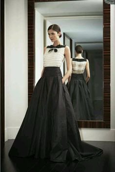 white sleeveless chiffon blouse with black floor-length skirt