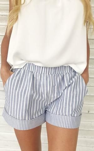 white sleeveless top with a relaxed fit and gray striped mini shorts with an elastic waist