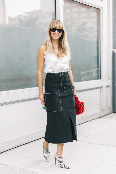 white sleeveless ruffle top with black maxi skirt with a high waist and relaxed fit