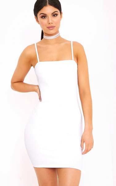 white, figure-hugging dress with spaghetti straps