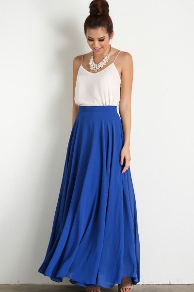 white top with spaghetti straps and blue, high-waisted maxi skirt