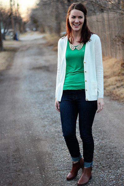 white cardigan with green blouse with scoop neckline and ankle jeans
