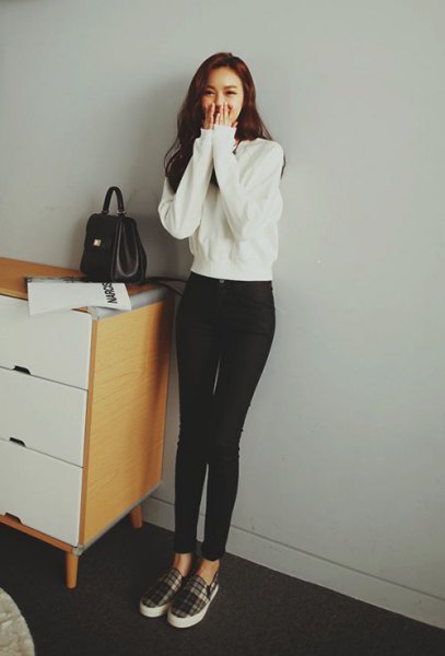 white sweater with black high-waisted skinny jeans and checked canvas shoes