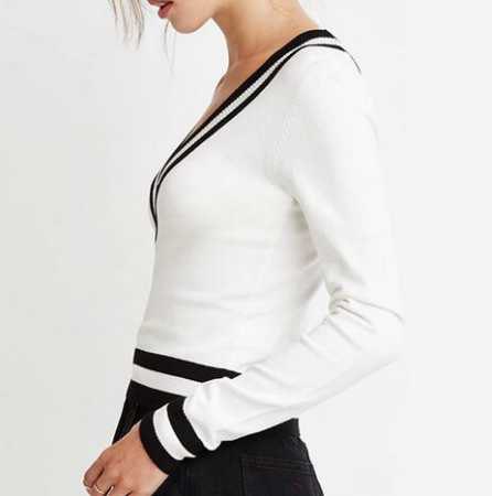 white sweater with black minirater skirt