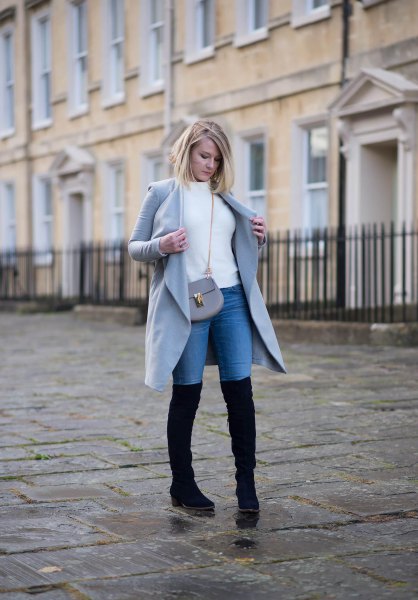 white sweater with gray long coat and blue high jeans