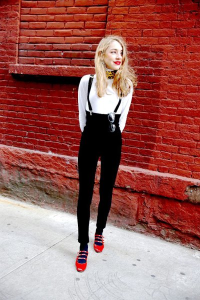 white sweater with high-waisted suspender jeans